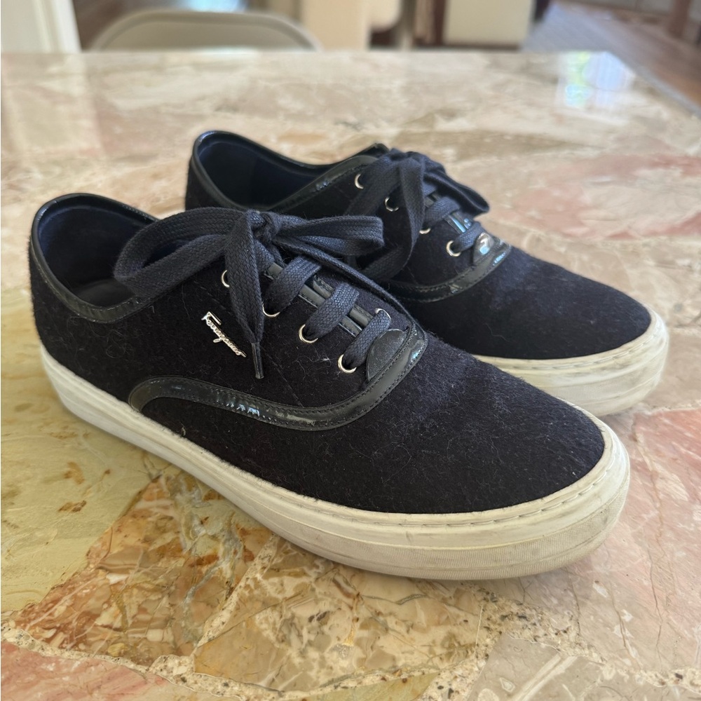 Navy blue Ferragamo sneakers with patent leather trim.